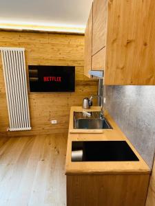 a kitchen with a sink and a counter top at Baita Snow Valtellina in Chiesa in Valmalenco +15 photos