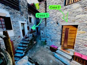 a building with two signs on the side of it at Baita Snow Valtellina in Chiesa in Valmalenco