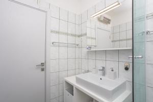 a white bathroom with a sink and a shower at Dalma Residence apartman Lavandella in Zaboric +45 photos