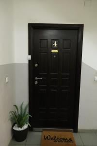 a black door with the number four on it at ILIEVSKI apartment 4 in Kumanovo