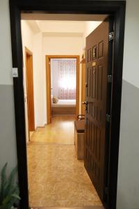 a hallway with a door open to a room at ILIEVSKI apartment 4 in Kumanovo