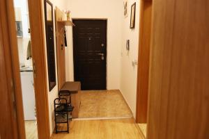 a hallway with a black door and a table and chairs at ILIEVSKI apartment 4 in Kumanovo +53 photos