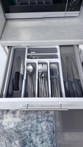 a drawer filled with utensils in a drawerasteryasteryasteryasteryasteryastery at Reverie Escape by Halisi in Ramsgate