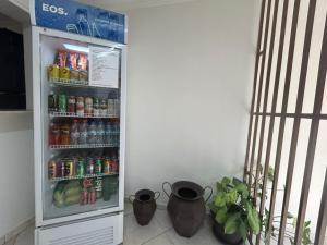 a refrigerator filled with lots of sodas and drinks at GOLDEN ROSE HOTEL in Campinas