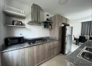 a kitchen with a stove and a refrigerator at Villa Labuena in Punta Cana
