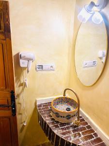 a bathroom with a sink and a mirror at Dar cheikh in Fez +52 photos