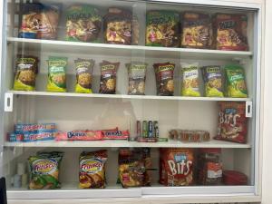 a refrigerator filled with lots of food and snacks at GOLDEN ROSE HOTEL in Campinas
