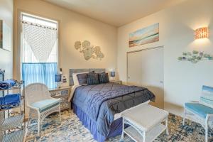a bedroom with a bed and chairs and a window at Steps to Pirate Cove Oregon Coast Condo with View in Depoe Bay