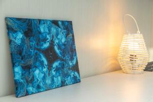 a painting on a wall next to a lamp at Willow's House Assisi Big house for Family and friends in Tordibetto