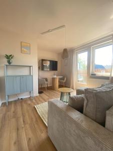 un salon avec un canapé et une table dans l'établissement Küstenbutze Büsum, à Büsum