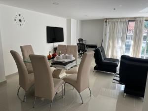 a living room with a dining room table and chairs at Luxury 3BR Apartment in the heart of Medellin in Medellín