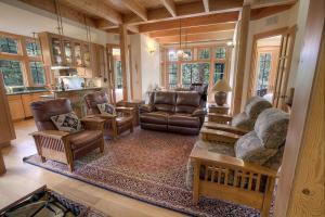 a living room with leather furniture and a kitchen at COH1444 - Fallen Leaf Relief in South Lake Tahoe