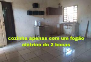 a kitchen with a sink and a refrigerator in a room at Casa REDÁRIO Cop 30 in Belém