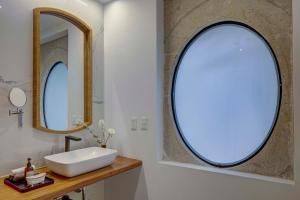 a bathroom with a sink and two mirrors at Roso Guest House in Mexico City +33 photos