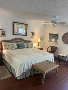 a bedroom with a large bed and a table at A18 - Crystal Cove Sapphire Beach West in St Thomas