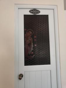 a door with a picture of a monkey on it at Fyangz Mini Karaoke Condo Staycation in Minglanilla +5 photos