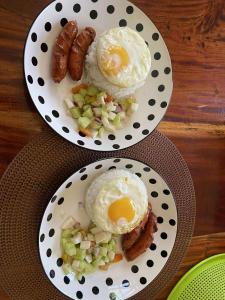 two plates of food with eggs and sausage and vegetables at CJ's Place Mabini in Mabini +10 photos