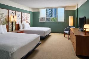 a hotel room with two beds and a desk at Pagoda Hotel in Honolulu +27 photos