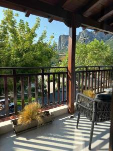 a porch with a bench and views of the mountains at Polyzos Luxury Suites Meteora #2 - Adults Friendly in Kalabaka +16 photos