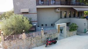 a motorcycle parked in front of a building at Polyzos Luxury Suites Meteora #6 - Adults Friendly in Kalabaka +18 photos