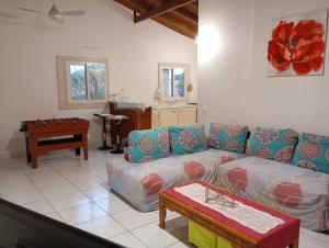 a living room with a couch and a table at L'Authentique Sikryé in Sainte-Anne