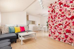 a living room with a wall covered in flowers at LILy練馬 in Tokyo