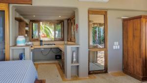 a small bathroom with a sink and a mirror at Las Olas Litibu Bungalow By The Sea in Higuera Blanca