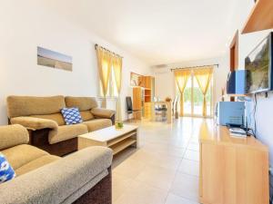 a living room with two couches and a tv at Modern Villa with Pool in Cala d'Or in Cala D'or