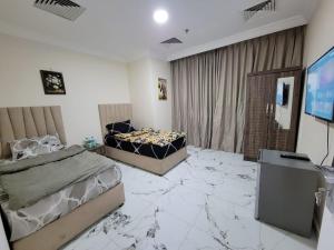 a bedroom with two beds and a marble floor at Everest vibes in Abu Dhabi