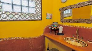 a yellow bathroom with a sink and a tub at Las Olas Litibú Wake up by the sea in Higuera Blanca +29 photos