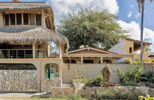 a house with a thatch roof at Las Olas Litibú Wake up by the sea in Higuera Blanca