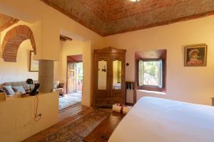 a bedroom with a bed and a living room at Hacienda Sepulveda Hotel & Spa in Lagos de Moreno +44 photos