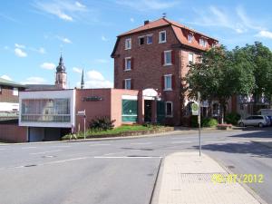 an empty street in front of a brick building at Hotel Adlerhof in Tauberbischofsheim