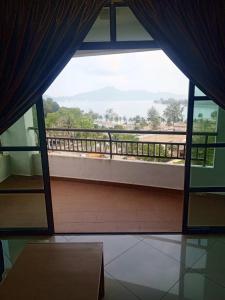 a view of a balcony from a room with a window at Marina sunset view in Lumut