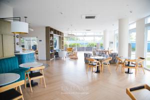 a room with tables and chairs and a room with windows at Unique Studio for Couples with Netflix & Mt Arayat View in San Fernando