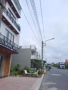 a building with a sign on the side of a street at Khách sạn sen hồng 1 in Cao Lãnh