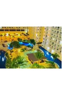 a view of a resort with a pool and buildings at Stay Manila in Sampong
