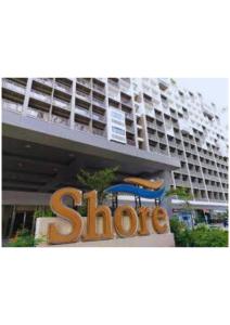 a store sign in front of a large building at Stay Manila in Sampong