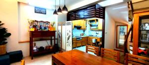 a kitchen with a wooden table and a refrigerator at GuInn in Hanoi