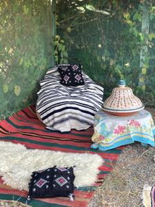 a group of blankets and pillows sitting on the ground at Halima Guesthouse in Larache