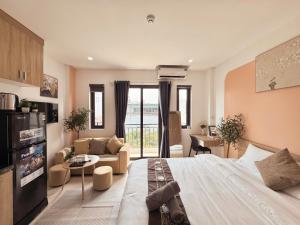 a bedroom with a large bed and a living room at The Little Home - Hoàng Hoa Thám - Cosy apartment - Center Hanoi in Hanoi