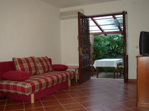 a living room with a red couch and a sliding door at Apartments Jadranka in Pula