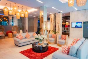 a living room with couches and a coffee table at Goldberry Lite Hotel in Iloilo City