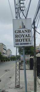 a sign for a grand royal hotel on a street at Grand Royal Hotel in Lahore