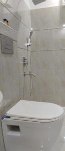 a bathroom with a shower and a toilet in it at Grand Royal Hotel in Lahore +35 photos