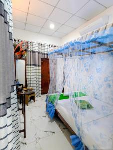 a bedroom with a bed with a mosquito net at Nehansa Resort and safari in Tissamaharama