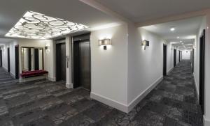 a hallway with white walls and a ceiling at TRYP by Wyndham Savannah in Savannah