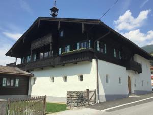 a building with a black and white building at Tauern Apartment Schrempf - Anna in Niedernsill