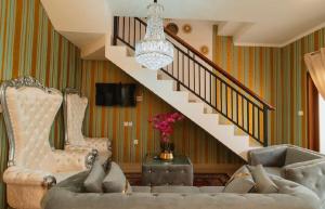 a living room with a couch and a staircase at Veeka Villa in Nusa Dua