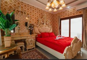 a bedroom with a large bed with a red bedspread at Veeka Villa in Nusa Dua +40 photos